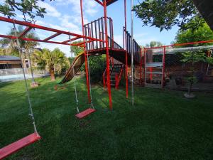 a playground with a slide in a yard at Ohana in Zárate