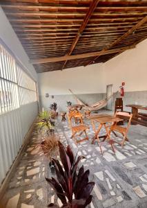 a room with tables and chairs in a room at La Palma Hostel in Maragogi