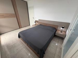 a bedroom with a bed in a small room at Modern one bedroom Apartment in Żurrieq