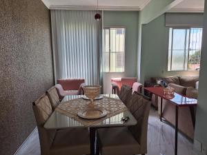 a dining room with a table and chairs at Lar Doce Lar in Itabira