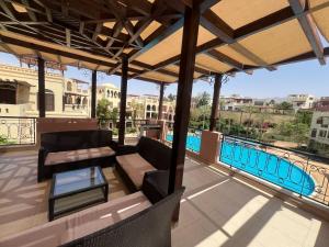 a patio with a view of a swimming pool at منتجع تالابيه العقبة in Aqaba +23 photos