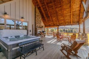 a large room with a hot tub on a wooden deck at Robin Hoods Retreat in Jefferson