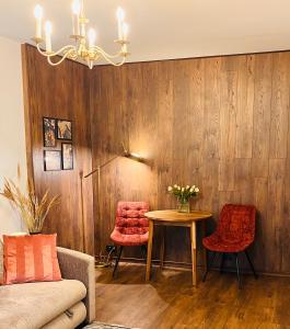 a living room with a table and two chairs at Li Amber Apartment Carnikava in Carnikava