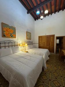 a bedroom with two beds and a table at Quinta María Hotel Boutique & Spa in Querétaro