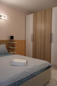 a bedroom with a bed with a sliding glass door at Maison Prestige in Monfalcone