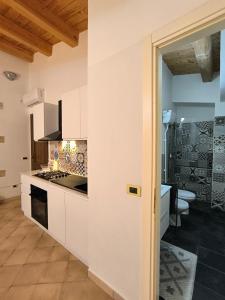 アヴォラにあるAvola Opera Houseの白いキャビネットとコンロ付きオーブンを備えたキッチン