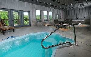 a large swimming pool in a room with a table and chairs at Beary Relaxed in Sevierville