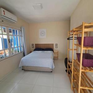 a bedroom with a bed and a large window at Pousada Odoyá Beach - Casal in Conde