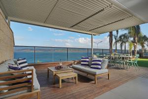 a living room with a view of the ocean at Levication Tiberias Luxury Private Pool Apartments in Tiberias