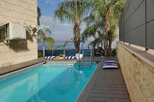a swimming pool with a view of the ocean at Levication Tiberias Luxury Private Pool Apartments in Tiberias