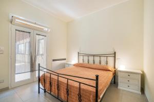 a bedroom with a bed and a large window at Villa Corbezzolo in Galatone +28 photos