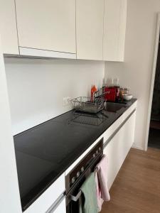a kitchen with a black stove top oven at Gemütliche Wohnung Centre Ville in Fribourg
