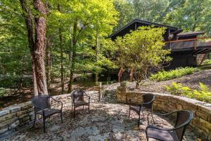 a group of chairs sitting in front of a stone wall at Elk Watch at Hound Ears in Valle Crucis