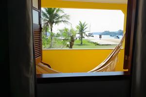 a view from a train window of a hammock at Casa Céu e Mar | Private Seaside Retreat with Breakfast Included in Angra dos Reis