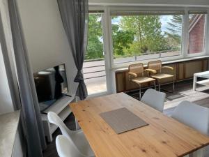 a dining room with a table and chairs and a fireplace at Ferienwohnung-Sylt in Baltrum