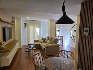 a living room with a couch and a table and chairs at Solsuites in Almería