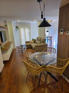 a living room with a glass table and chairs at Solsuites in Almería