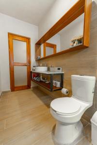 a bathroom with a white toilet in a room at Villas Manglar Sisal 5 by WoWay Experiences in Sisal