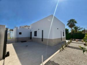 a white house with a glass facade at Villa Jupiter by Albir Proper Properties in Albir