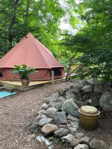 a tent with a pile of rocks and a plant at Romantic Botanical Bell Tent for a Fantastic Glamping Experience in Southbury, Connecticut in Southbury