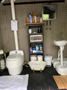 a bathroom with a toilet and a sink at Romantic Botanical Bell Tent for a Fantastic Glamping Experience in Southbury, Connecticut in Southbury