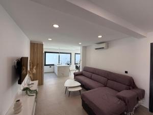 a living room with a couch and a table at Villa Jupiter by Albir Proper Properties in Albir