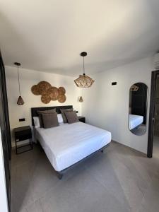 a bedroom with a large white bed and a mirror at Villa Jupiter by Albir Proper Properties in Albir +21 photos