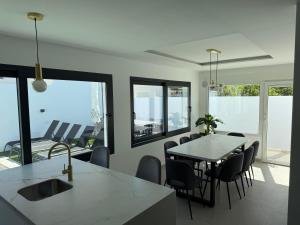 a kitchen and dining room with a table and chairs at Villa Jupiter by Albir Proper Properties in Albir