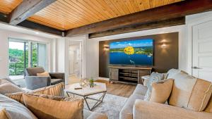 a living room with a couch and a tv at Amazing Lakefront Paradise with Perfect Location in Osage Beach