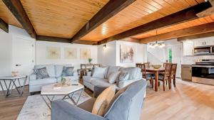 a living room with a couch and a table at Amazing Lakefront Paradise with Perfect Location in Osage Beach