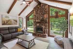 a living room with a couch and a fireplace at 17 Lakefront Acres, Private Dock, Firepit, Pool Table, Kayaks, Fishing in Laurie
