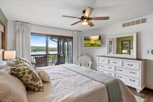 a bedroom with a bed and a ceiling fan at 17 Lakefront Acres, Private Dock, Firepit, Pool Table, Kayaks, Fishing in Laurie