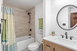 a bathroom with a sink and a toilet and a mirror at 17 Lakefront Acres, Private Dock, Firepit, Pool Table, Kayaks, Fishing in Laurie +84 photos