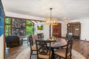 a dining room with a table and chairs at 17 Lakefront Acres, Private Dock, Firepit, Pool Table, Kayaks, Fishing in Laurie