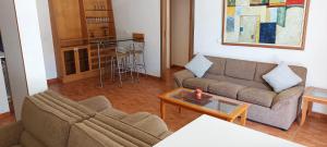 a living room with a couch and a table at 4-Bedroom chalet for Ski and Summer in Kfardebian