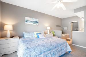 a bedroom with a bed and a ceiling fan at Experience Lakeside Living at Its Finest: Stunning Views and Prime Location! in Laguna Beach +35 photos