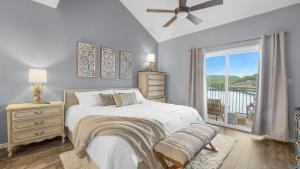 a bedroom with a bed and a window with a balcony at Boat Slip, 3 Pools, Golf, Ozarks Ampitheater, & Amazing Lake Views at the 13mm Big Niangua in Roach +29 photos