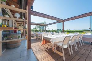 a dining room with a white table and chairs at Agriturismo coda di gatto in Eraclea