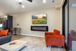 a living room with a couch and a fireplace at Family-Fun Lakeside Luxury at Topsider in Osage w/ 2 Pools, Prime Views Pack N' Play & Games in Laguna Beach