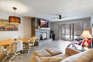 a living room with a couch and a table at Family Fun at Lake Vibin' Lazy Days Osage Beach w/ 2 Pools, Playground, Games & Calm Water in Damsel