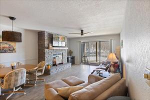 a living room with a couch and a table at Family Fun at Lake Vibin' Lazy Days Osage Beach w/ 2 Pools, Playground, Games & Calm Water in Damsel