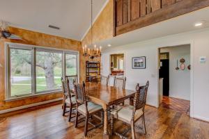a dining room with a wooden table and chairs at Lakes View at Hound Ears in Valle Crucis