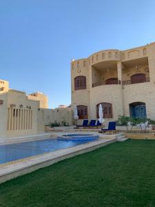 a building with a swimming pool in front of it at iteru inn in Tunis