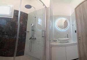 a bathroom with a shower and a sink at Authentic appartement in Aíyira +3 photos