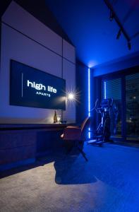 a room with a tv and a chair and a desk at High Life Aparts in Warsaw +18 photos