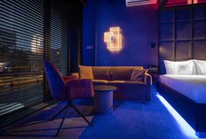 a bedroom with a bed and a couch and a chair at High Life Aparts in Warsaw