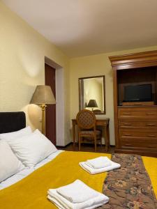 a hotel room with a bed with towels on it at Hotel Wintera Gudauri in Gudauri