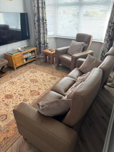 a living room with a couch and a tv at Royville in Coleraine