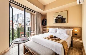 a hotel room with a bed and a balcony at Kukun Edition Marsella Juarez in Mexico City