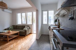 a kitchen and living room with a couch and a table at Cozy in Varna in Varna City +32 photos